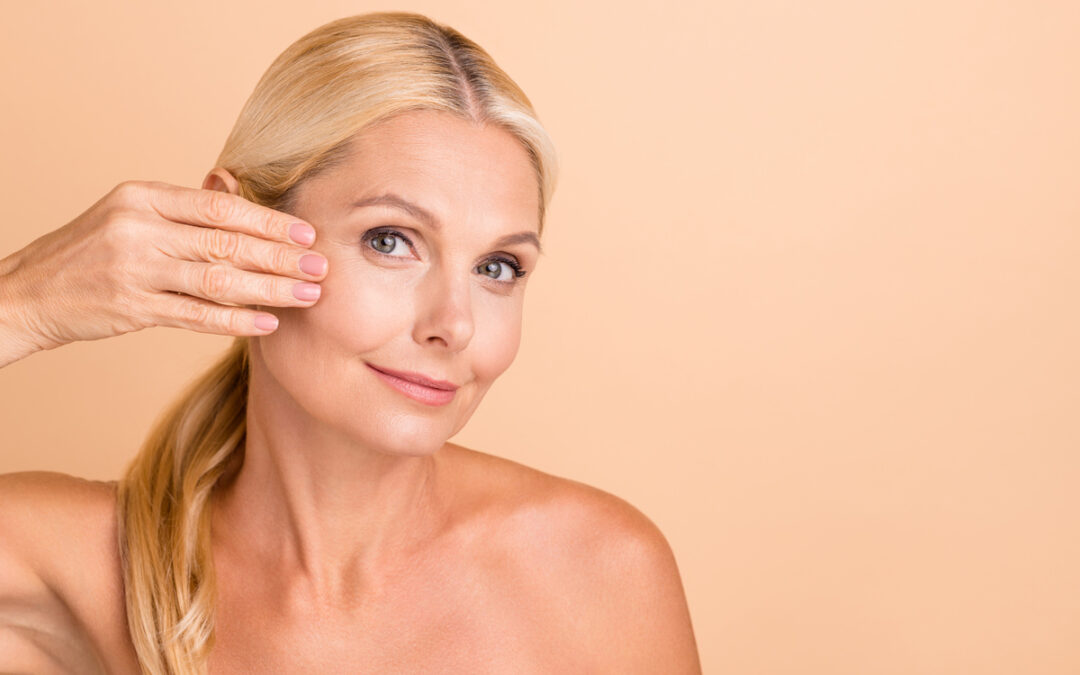 Mature woman touching her face showing skin firmness results after XERF sessions for radiofrequency skin tightening